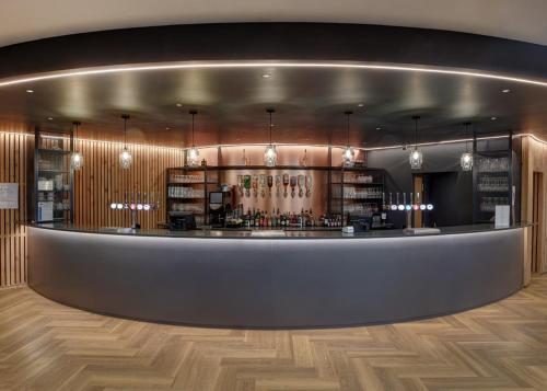 a bar in a room with wood floors and a counter at Aber Bay Holiday Park in Aberystwyth