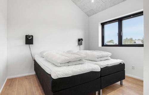 a stack of pillows on a bed in a room at Stunning Home In Saltum With Sauna in Saltum