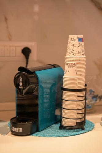 a stack of paper towels next to a toaster at VibeS in Centro apartment & rooms in Pagani