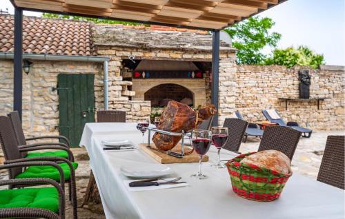 a table with glasses of wine on a patio at Gorgeous Home In Benkovac in Benkovac