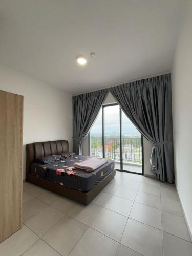 a bedroom with a large bed and a large window at Lovely Green Forest in Sandakan