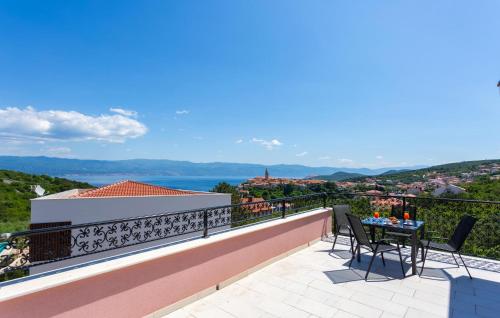 a view from the balcony of a house with a table and chairs at Pet Friendly Home In Vrbnik With Wifi in Vrbnik