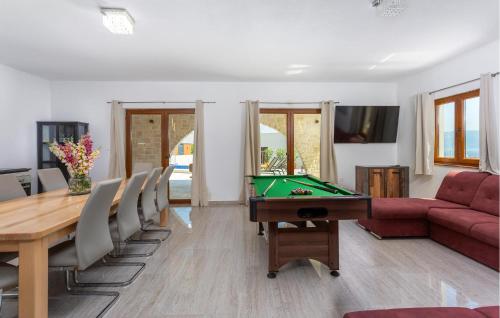 a living room with a pool table and a couch at Pet Friendly Home In Vrbnik With Wifi in Vrbnik
