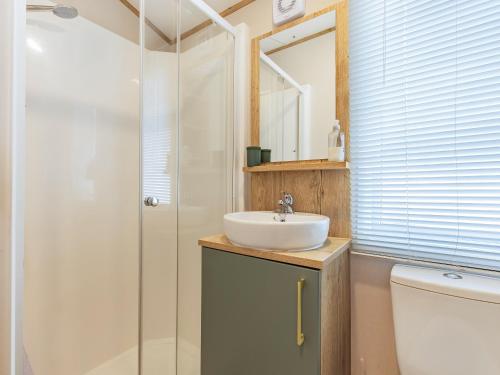 a bathroom with a sink and a shower at Seren in Brigham