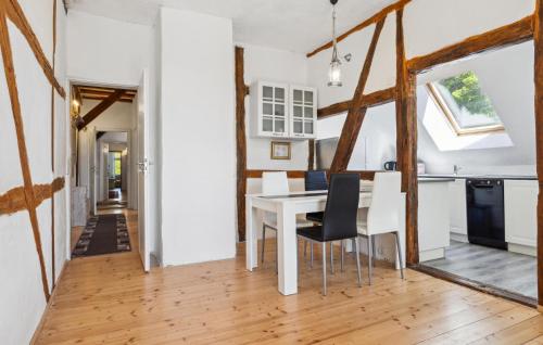 a kitchen and dining room with a white table and chairs at Ferienwohnung Stefanie in Rambin