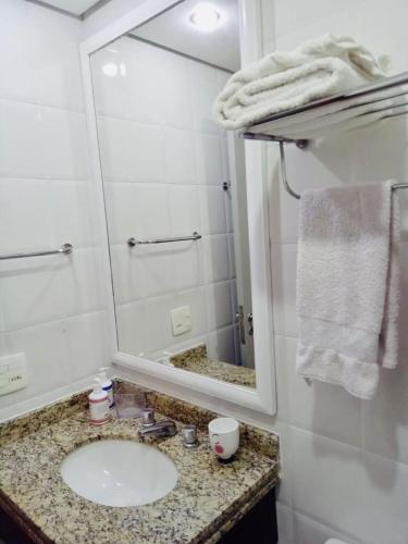 a bathroom with a sink and a mirror at The Palace Flat Moema in Sao Paulo