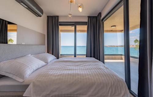 a bedroom with a bed with a view of the ocean at Cozy Apartment In Povljana With Wifi in Povljana