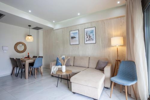 a living room with a couch and a table at Villa Hanioti Dream seafront in Hanioti