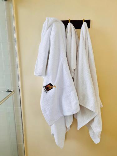 a group of towels hanging on a rack in a bathroom at Lookout sirwa in Naivasha