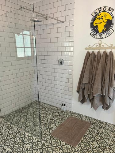 a bathroom with a shower with towels on a wall at Lavender Trout Guest Farm in Nottingham Road
