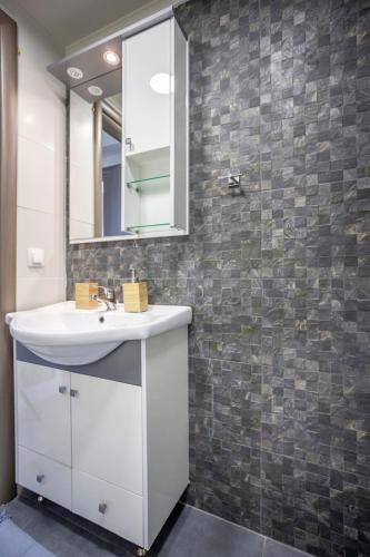 a bathroom with a white sink and a mirror at Villa Hanioti Dream seafront in Hanioti