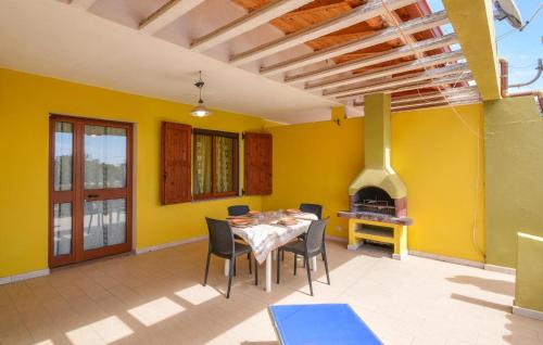 a dining room with a table and a fireplace at Secca in Costa Rei