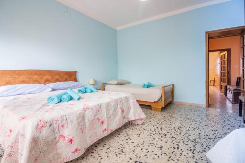 a bedroom with a bed with blue towels on it at Ploaghe - Cozy House with Patio! in Ploaghe
