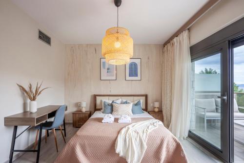 a bedroom with a bed and a desk and a window at Villa Hanioti Dream seafront in Hanioti
