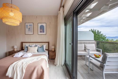 a bedroom with a bed and a balcony at Villa Hanioti Dream seafront in Hanioti