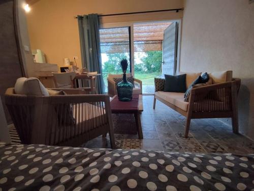 a living room with two chairs and a couch at La cabane d'Alcée in Vacqueyras