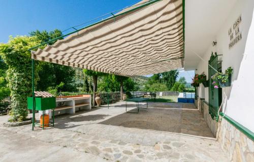 a large wooden pergola on the side of a building at Nice Home In La Puebla De Los Infan in La Puebla de los Infantes