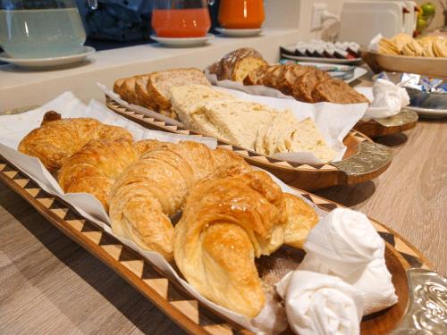 three baskets filled with different types of pastries on a table at GS Hotel in Salta