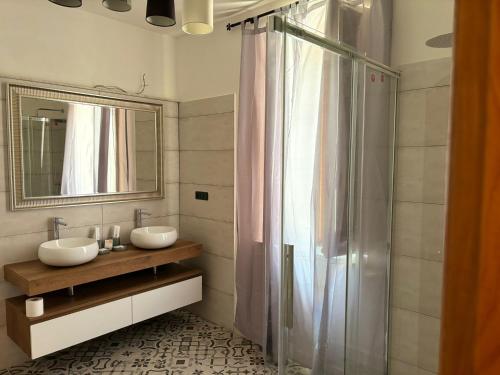 a bathroom with two sinks and a shower at Amas Apartment in Fondi