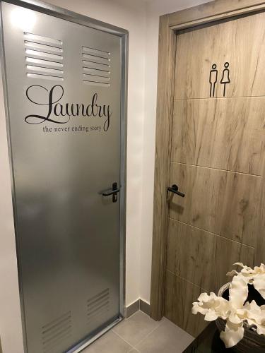 a shower door with the words laundry on it at GARDEN HOUSE Madrid in Madrid