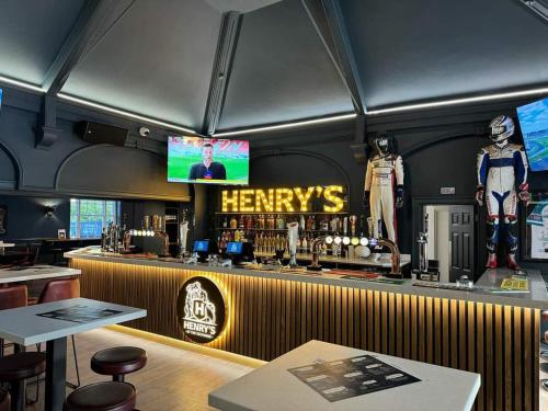 a bar in a restaurant with a tv above it at The Exchange Hotel in Brigg