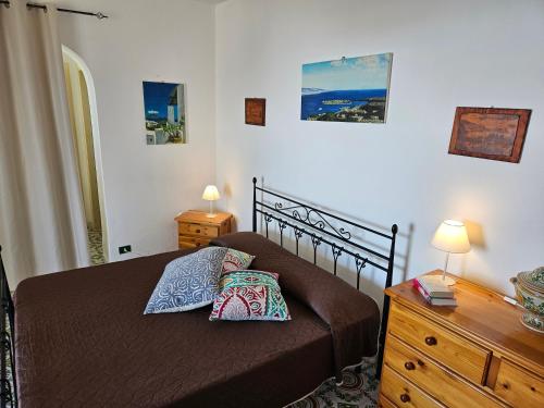 a bedroom with a bed with two pillows on it at Villa Belvedere in Lipari