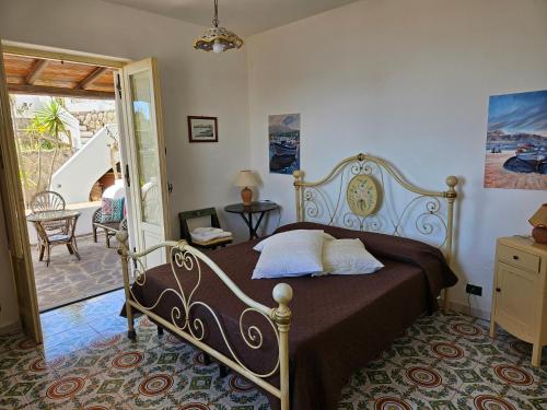 a bedroom with a bed and a door to a patio at Villa Belvedere in Lipari