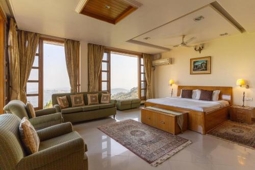 a bedroom with a bed and a living room at PleasantVille by VEO - Part of StayVista in Nāhan