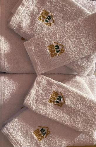 a group of white napkins with gold insignias on them at Vila Dias in Mértola