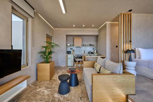 a living room with a couch and a kitchen at Nami Suites - Alenia in Chania Town