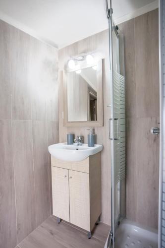 a bathroom with a sink and a shower at Villa Hanioti Dream seafront in Hanioti