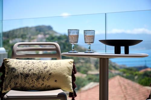 two wine glasses on a table with a pillow at Nami Suites - Alenia in Chania Town
