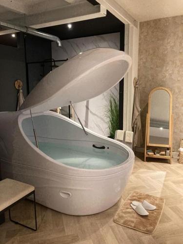 a large bath tub in a room with at Sparkle privé wellness B&B in Franeker