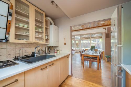 a kitchen with a table and a dining room at Family private house in Dubulti, Jurmala, 400m to the beach in Jūrmala