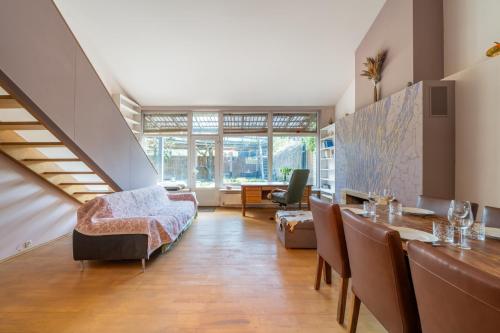 a living room with a dining room table and chairs at Family private house in Dubulti, Jurmala, 400m to the beach in Jūrmala