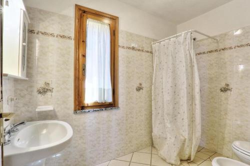 a bathroom with a sink and a shower curtain at Casa Ilva - Colle Paradiso Experience in Capoliveri