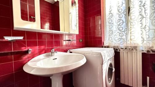 a bathroom with a sink and a washing machine at Bilocale con portico a Numana - N175 in Numana