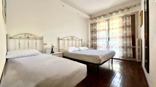 a bedroom with two beds and a window at Bilocale con portico a Numana - N175 in Numana
