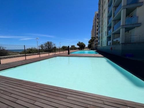 a large swimming pool next to a building at Apartment Sea Breeze I La Manga in La Manga del Mar Menor