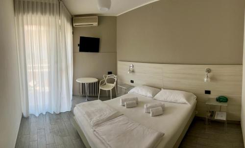 Postel nebo postele na pokoji v ubytování Hotel Astoria