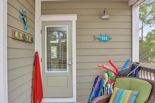a front door of a house with a basket of umbrellas at Embreeze Beach Casa by Pristine Properties Vacation Rentals in Highland View