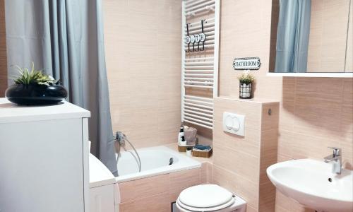 a small bathroom with a toilet and a sink at Apartment Angelus in Zagreb