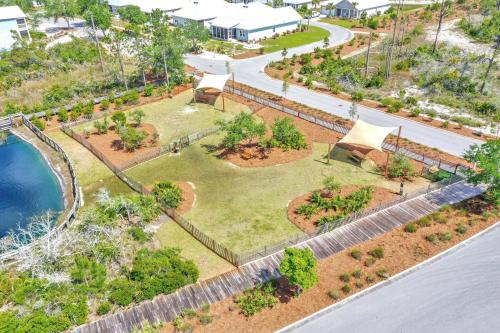 an aerial view of a park with trees and a pond at Embreeze Beach Casa by Pristine Properties Vacation Rentals in Highland View