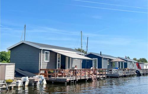 a row of houses on a dock on the water at Awesome Home In Breukelen in Breukelen