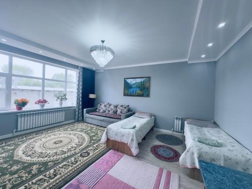 a living room with blue walls and a couch at Guest house B&B in Kochkor