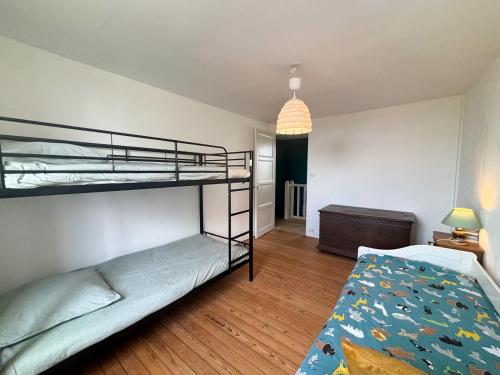 a bedroom with two bunk beds and a desk at La maison des écuyers avec grand jardin et barbecue in Rônai