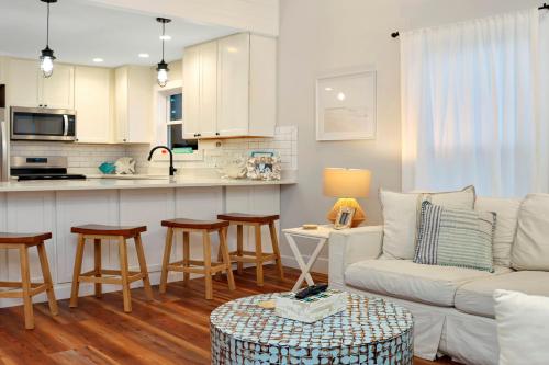 a living room with a couch and a kitchen at The Surf Ranch by Pristine Properties Vacation Rentals in Port Saint Joe