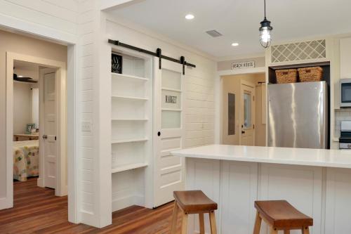 a kitchen with white walls and a counter and stools at The Surf Ranch by Pristine Properties Vacation Rentals in Port Saint Joe