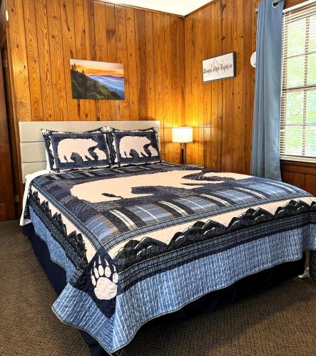 a bedroom with a bed in a wooden wall at The Evening Shade River Lodge and Cabins in Chimney Rock