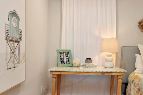 a table in a room with a lamp and a bed at The Surf Ranch by Pristine Properties Vacation Rentals in Port Saint Joe